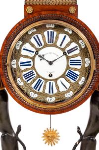 A French Egyptian Revival Gilt Bronze Mounted Mahogany Clock