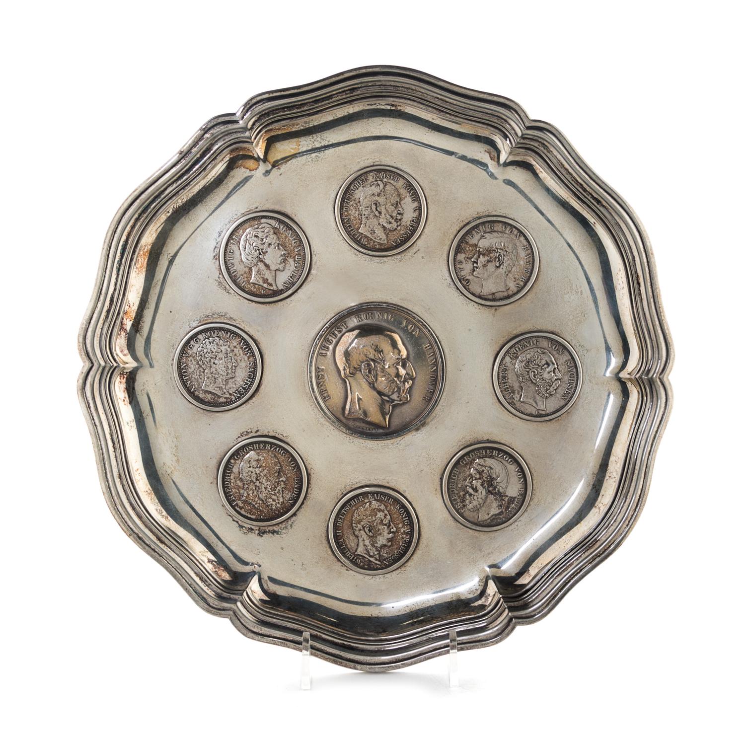 A German Silver Tray, 19th/20th Century, of shaped circular form, inset with eight 19th and 20th five-mark coins centered with a silver