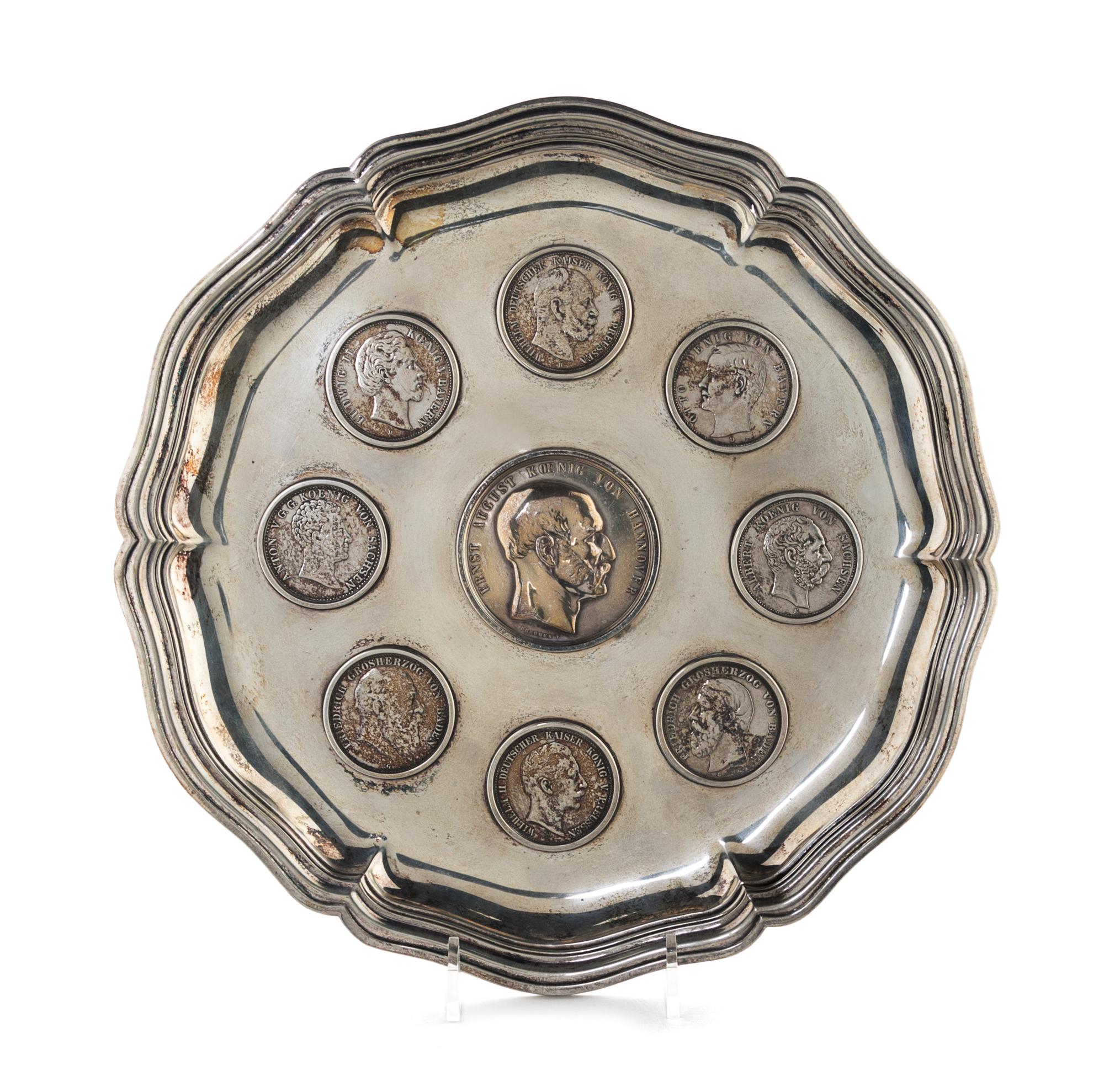 A German Silver Tray, 19th/20th Century, of shaped circular form, inset with eight 19th and 20th five-mark coins centered with a silver