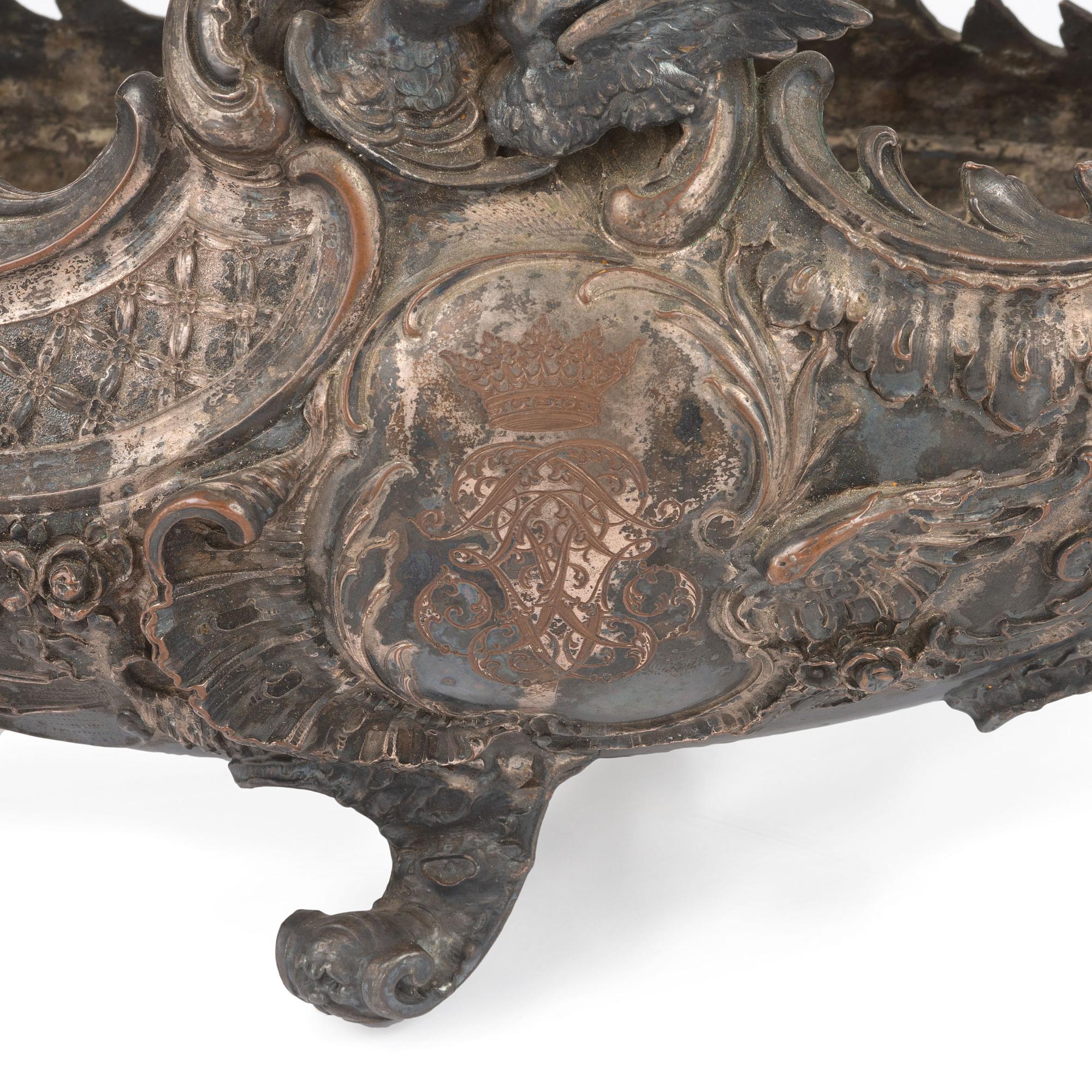 An Ornate Silverplate Centerpiece Bowl of Boat Form with Cherubs