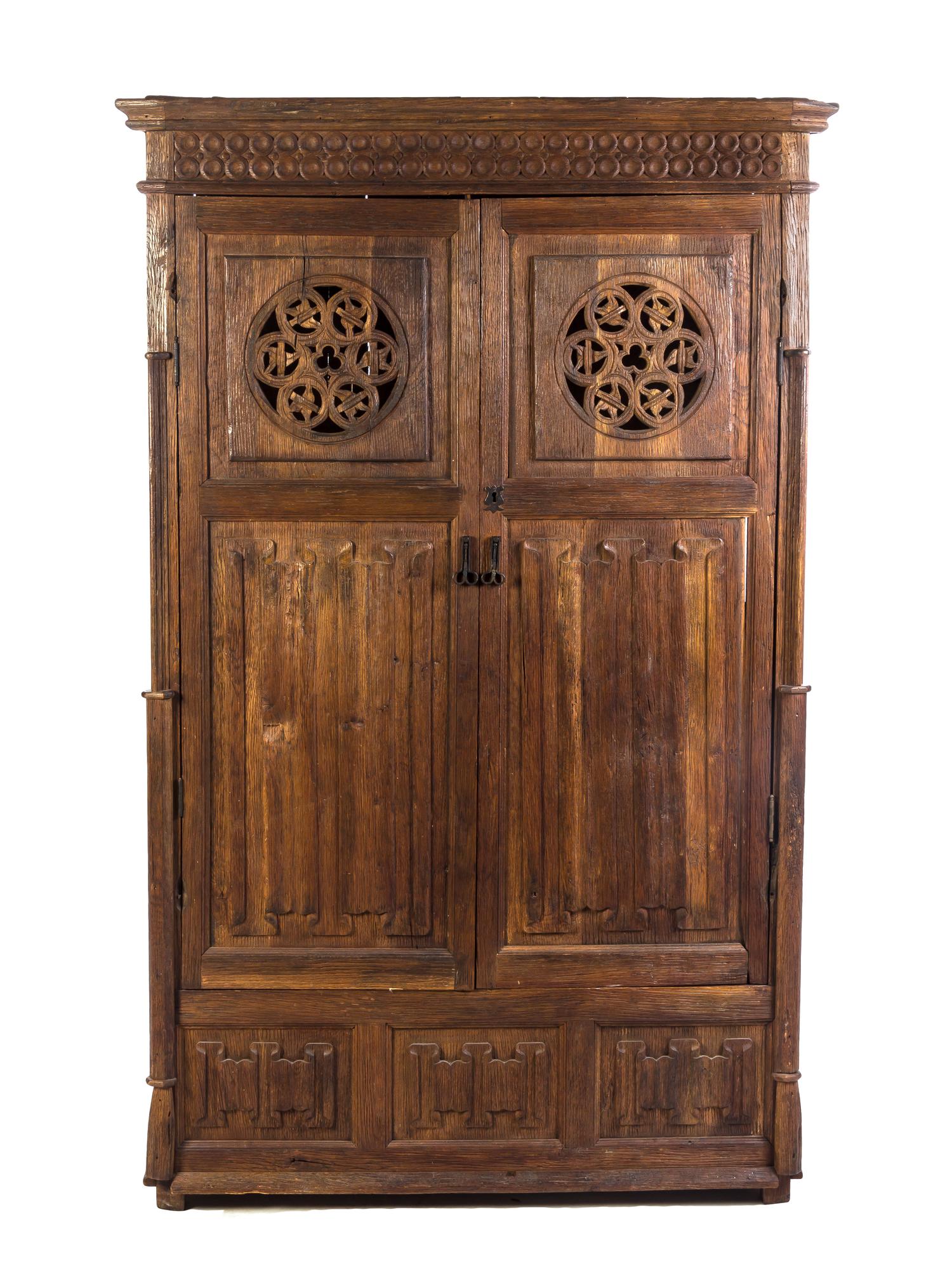 A Gothic Revival Oak Cupboard, Height 74 3/8 x width 46 x depth 21 1/2 inches.