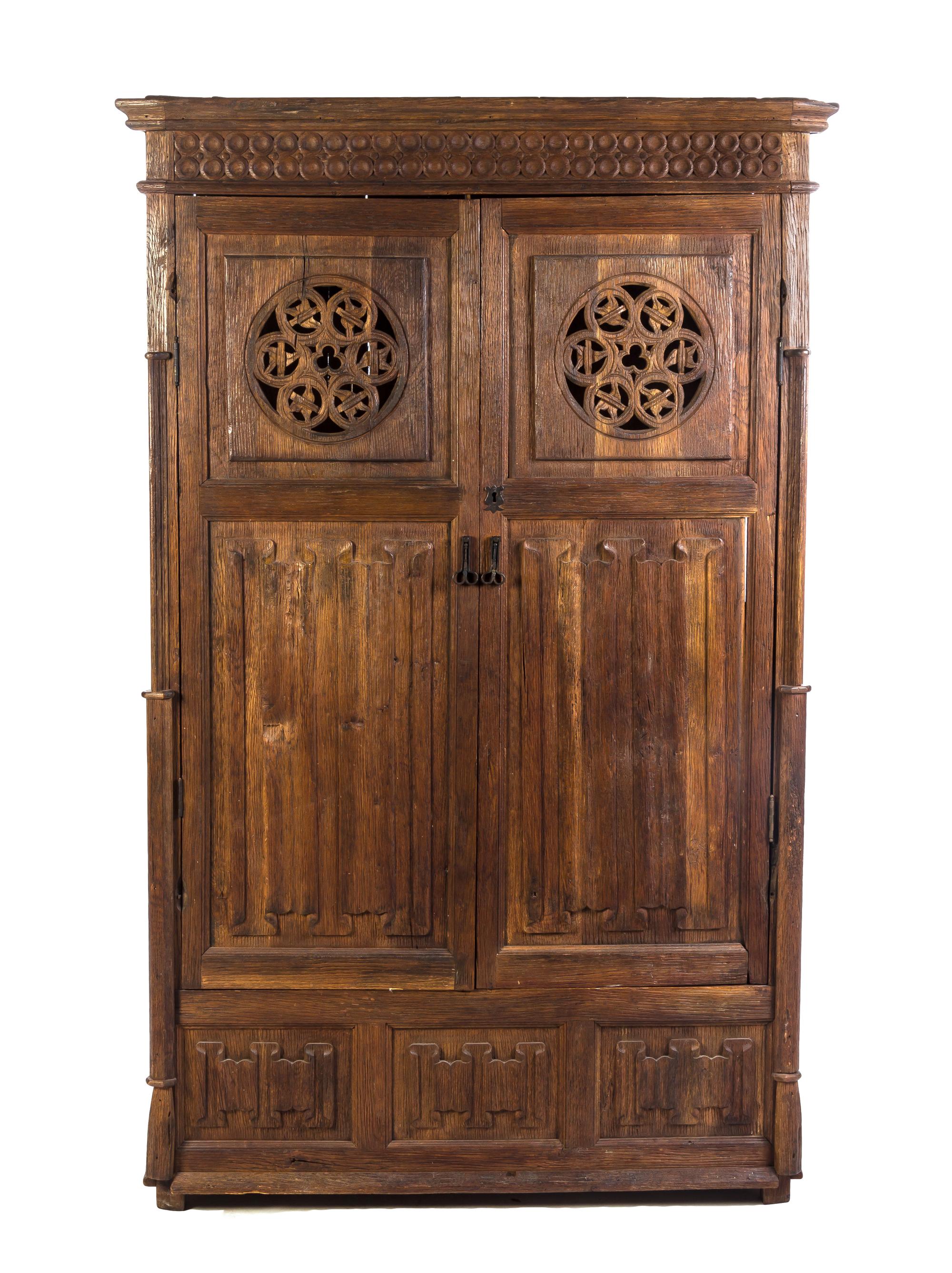 A Gothic Revival Oak Cupboard, Height 74 3/8 x width 46 x depth 21 1/2 inches.