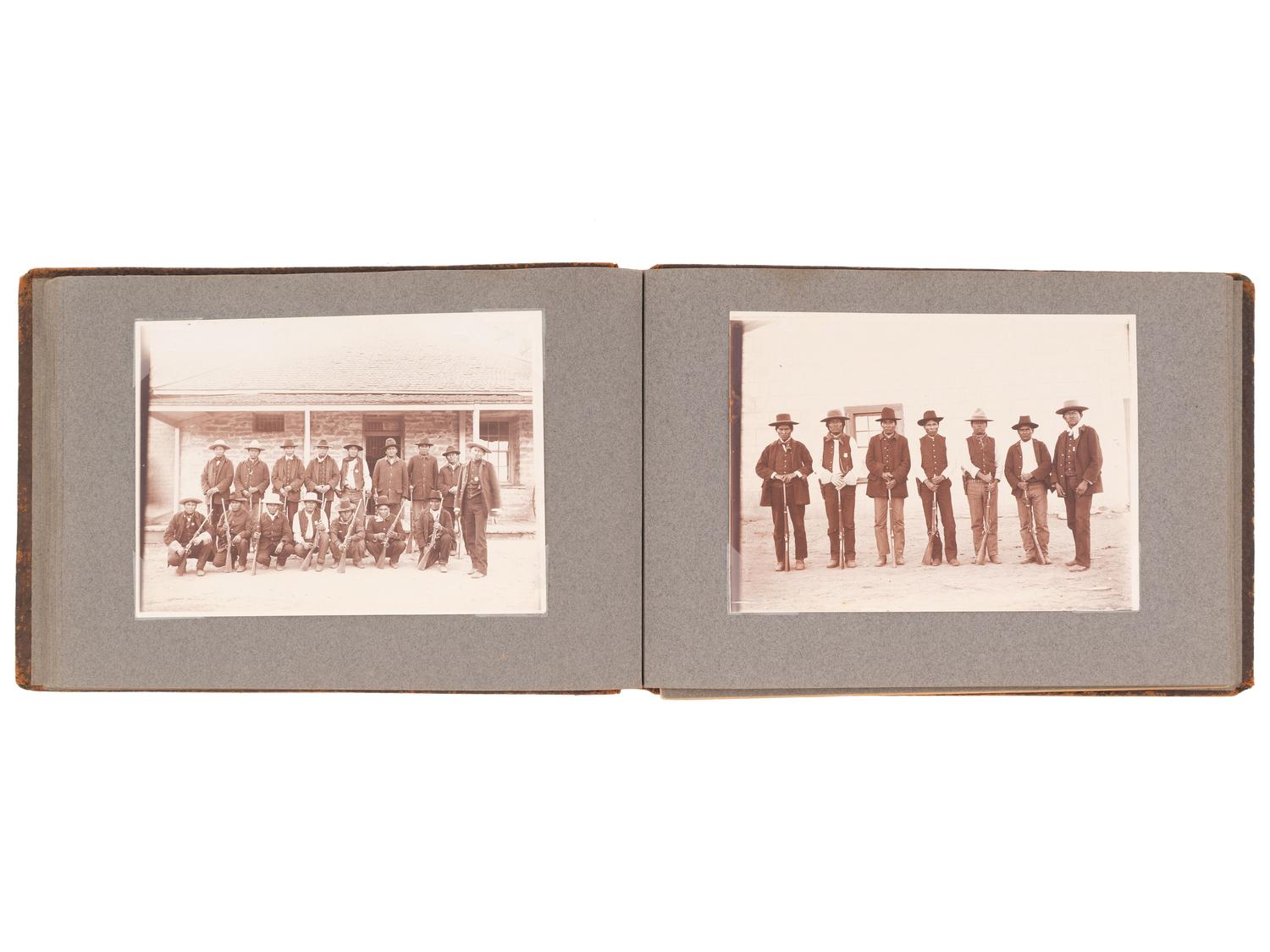[NATIVE AMERICANS]. JONES, John Edward (1863-1922), photographer. Album containing 50 photographs of the San Carlos Indian Agency, including Apache civilians and police, agency buildings and dwellings, and scenic views. Ca 1904.
