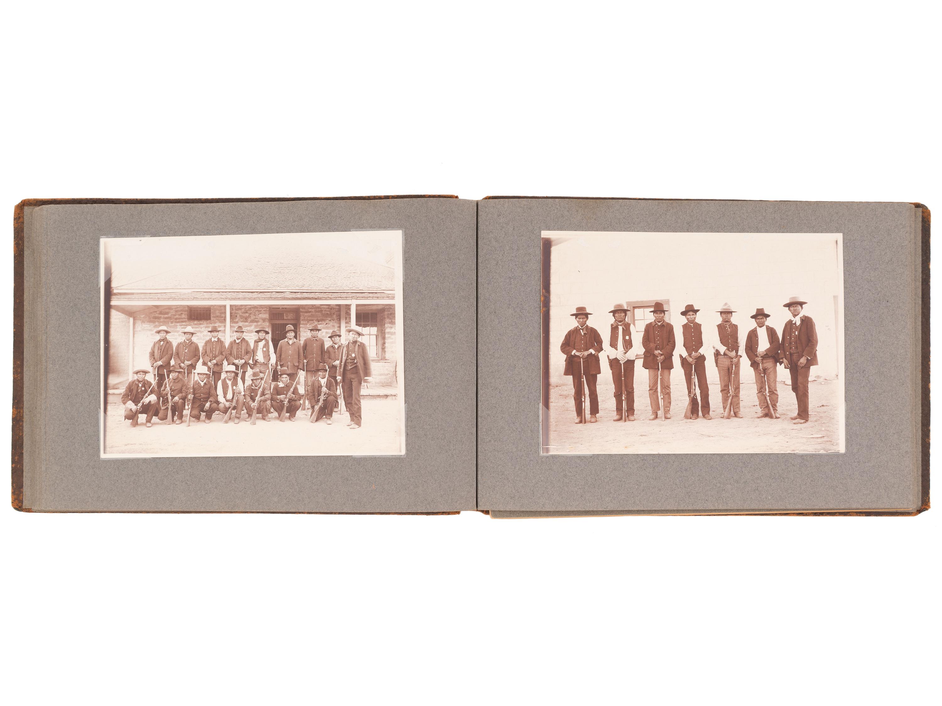 [NATIVE AMERICANS]. JONES, John Edward (1863-1922), photographer. Album containing 50 photographs of the San Carlos Indian Agency, including Apache civilians and police, agency buildings and dwellings, and scenic views. Ca 1904.