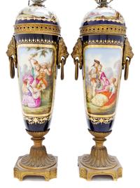 A Pair of Sevres Style Porcelain and Gilt Bronze Mounted Urns, Height 16 1/2 inches.
