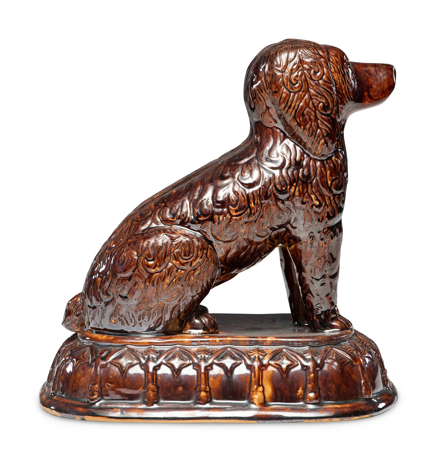 A Rare Rockingham Glazed Molded Yelloware Forward-Facing Dog