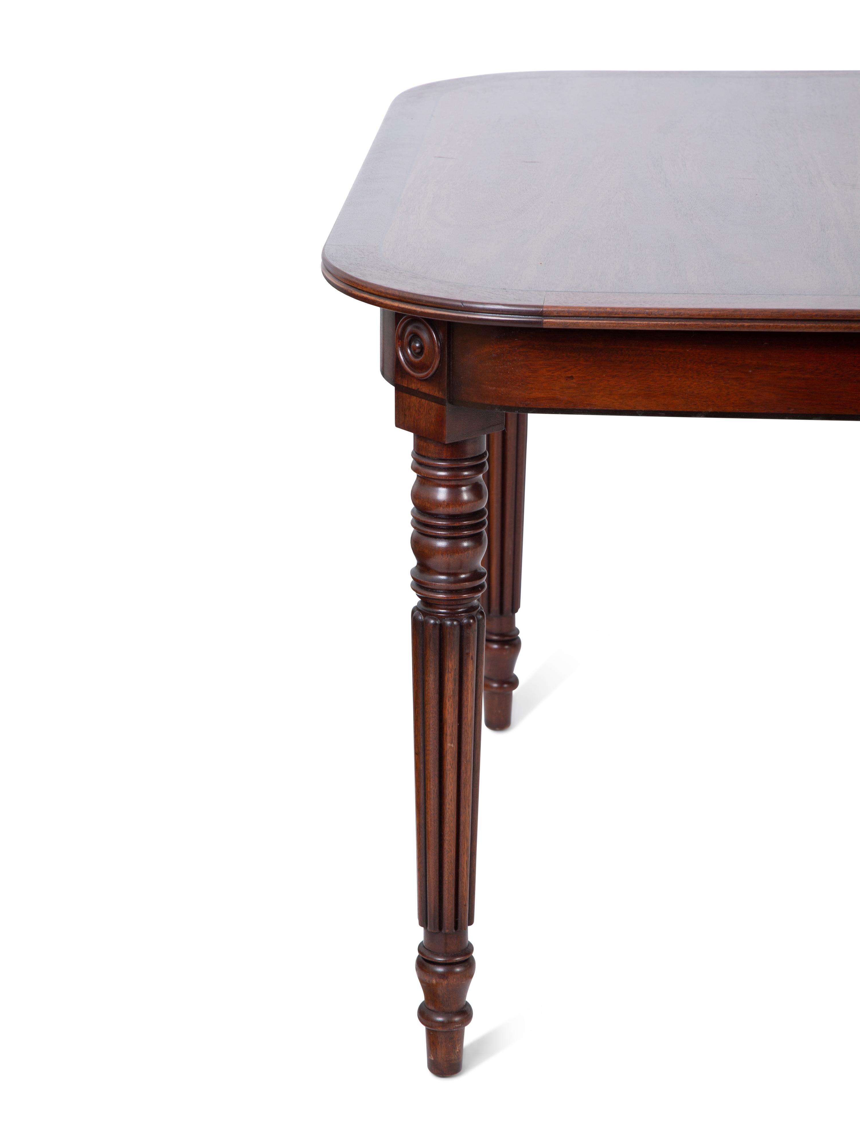 A Regency Style Inlaid Mahogany Dining Table