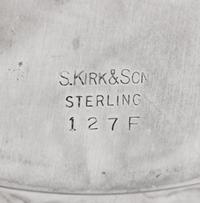 A Set of Eight S. Kirk and Son Repousse Silver Bread Plates