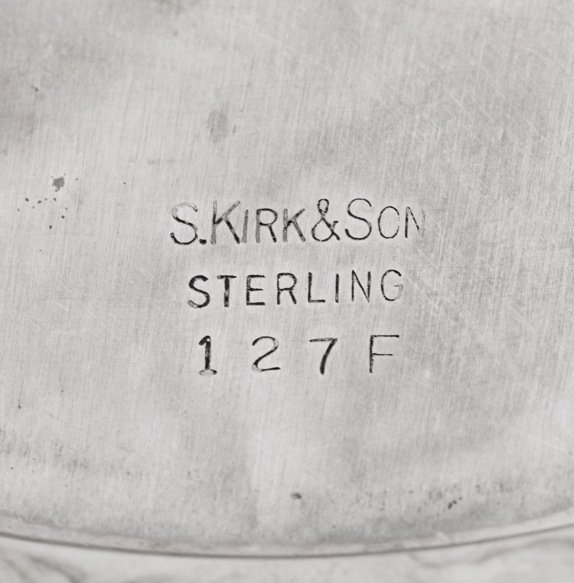 A Set of Eight S. Kirk and Son Repousse Silver Bread Plates