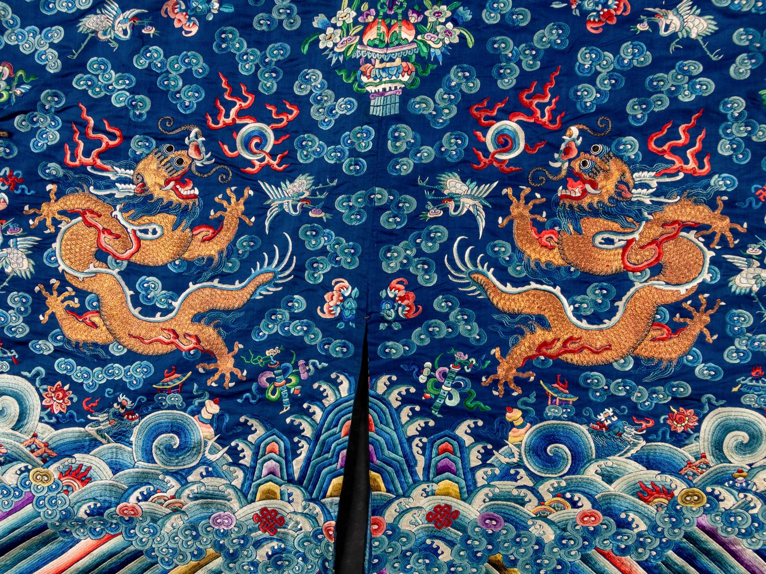 A Chinese Blue Ground Embroidered Silk Dragon Robe, Jifu, Late 19th Century 清晚期 藍緞地綉云龍紋吉服