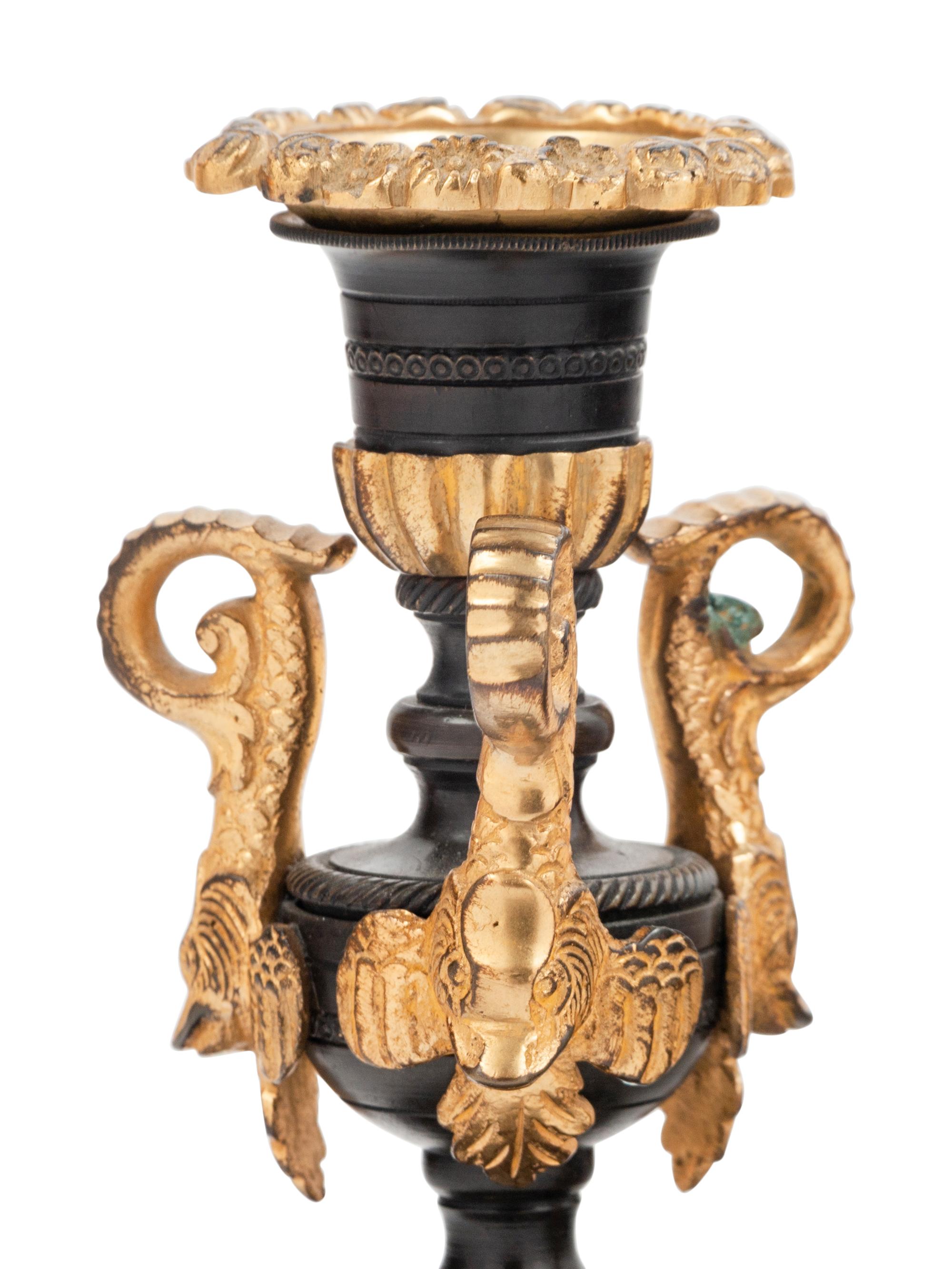 A Pair of Patinated and Gilt Bronze Candlesticks