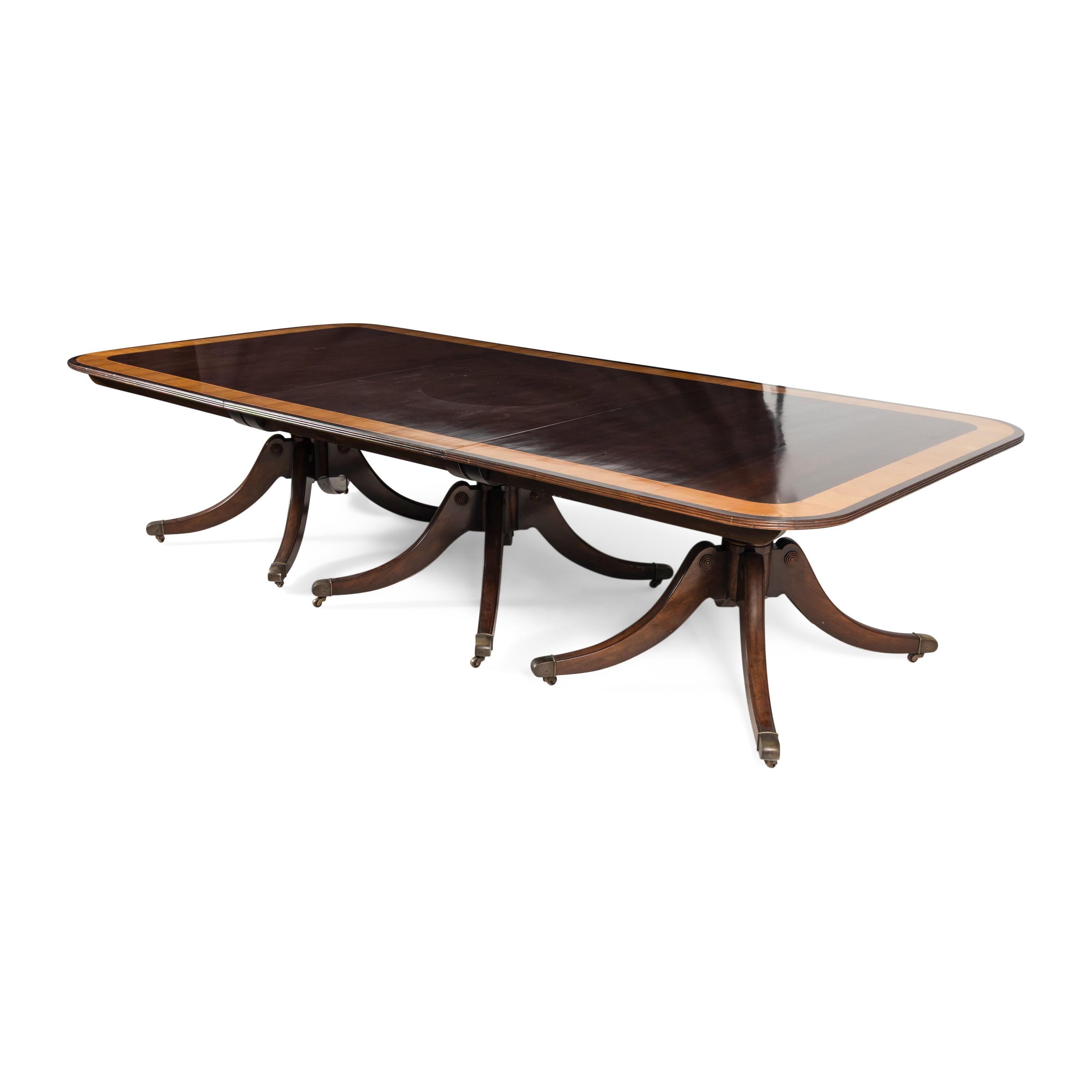 A Regency Style Mahogany and Satinwood Three-Pedestal Dining Table