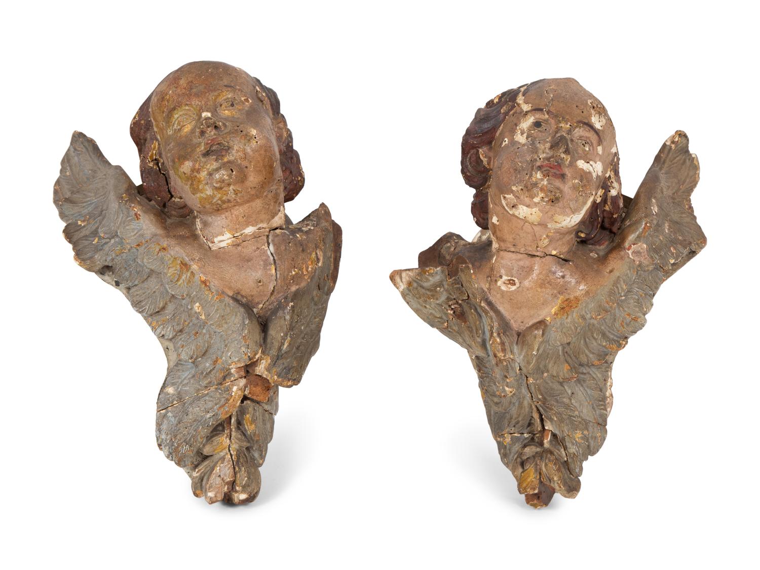 A Pair of Italian Polychromed and Parcel Gilt Carved Wood Angel Head Wall Mounts