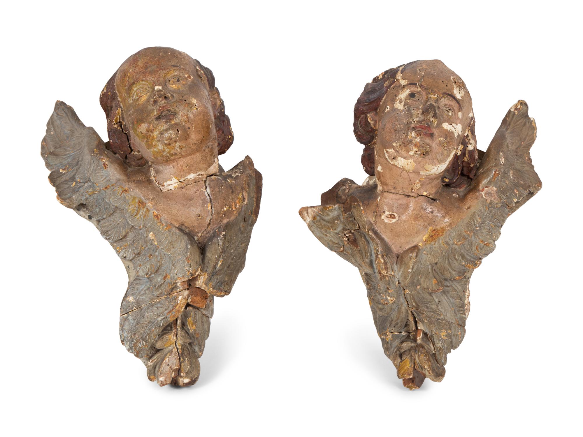 A Pair of Italian Polychromed and Parcel Gilt Carved Wood Angel Head Wall Mounts