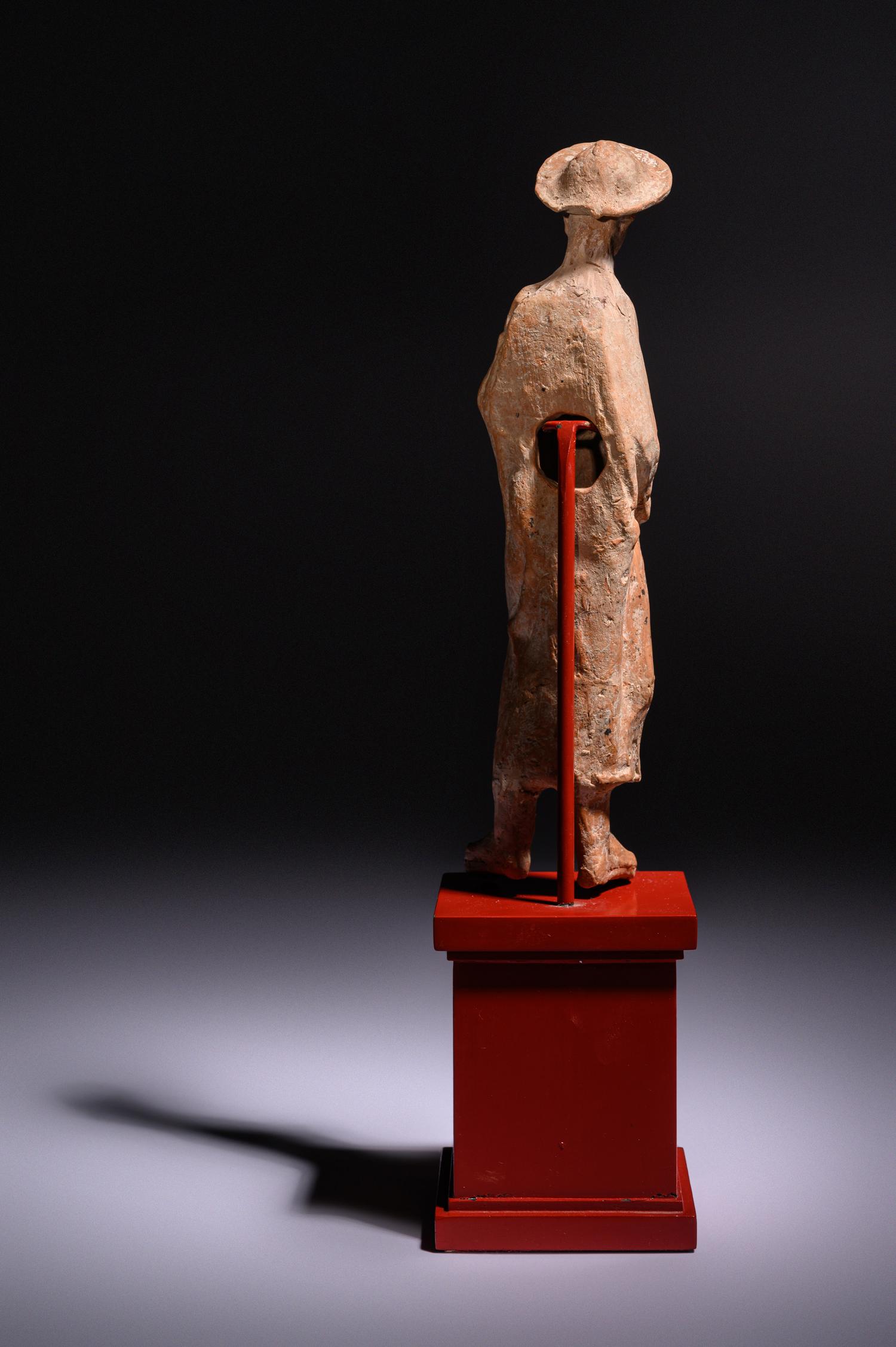 A Greek Terracotta Woman Wearing a Polos (broad-rimmed hat)