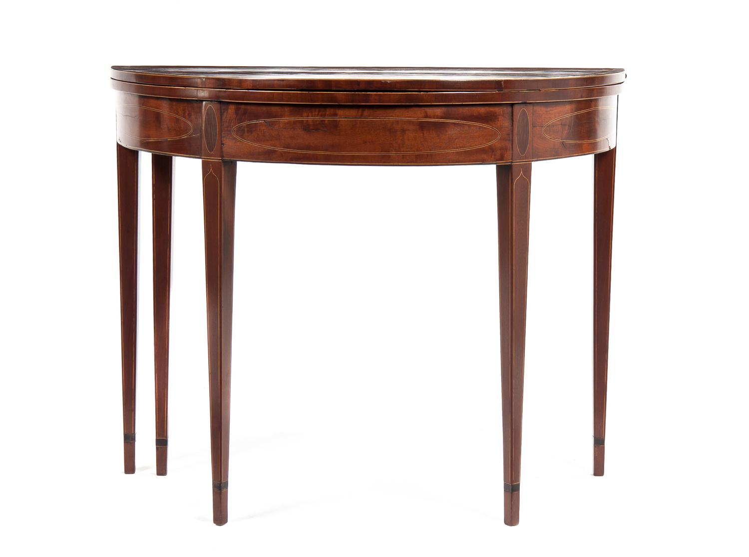 A Federal Mahogany Demilune Flip-Top Games Table, Height 29 1/2 x width 35 x depth 17 1/2 inches (closed).