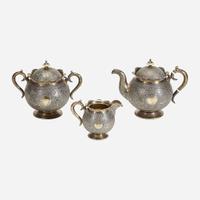 A Russian Parcel-Gilt Silver and Niello Three-Piece Tea Service Mikhail Fyodorovich Sokolov, assay master Anatoly Appollonovich Artsybashev, Moscow, 1893