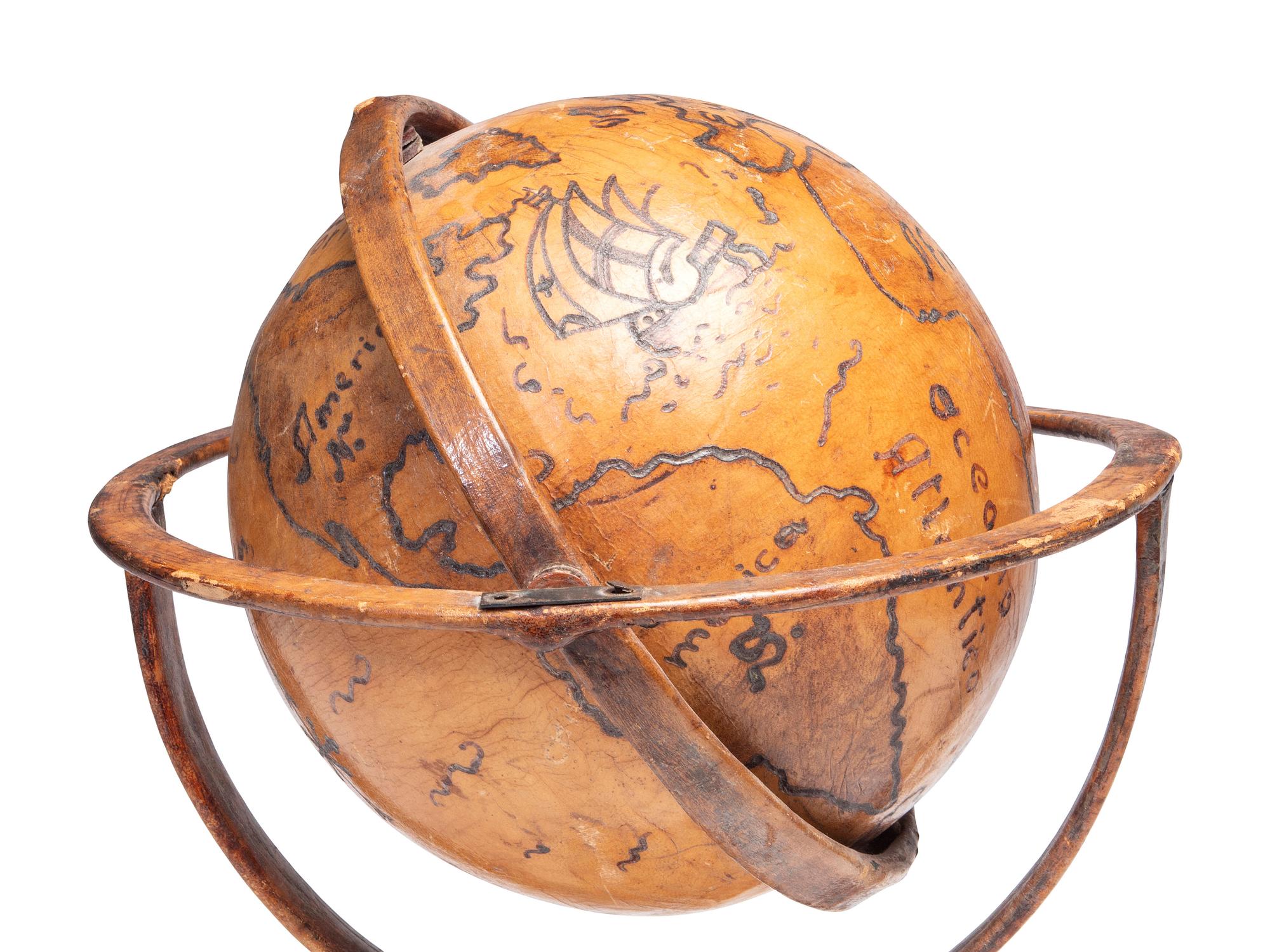 A Folk Art Painted Leather Covered Tabletop Globe