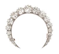 An Edwardian Platinum Topped Gold and Diamond Crescent Brooch, 8.50 dwts.