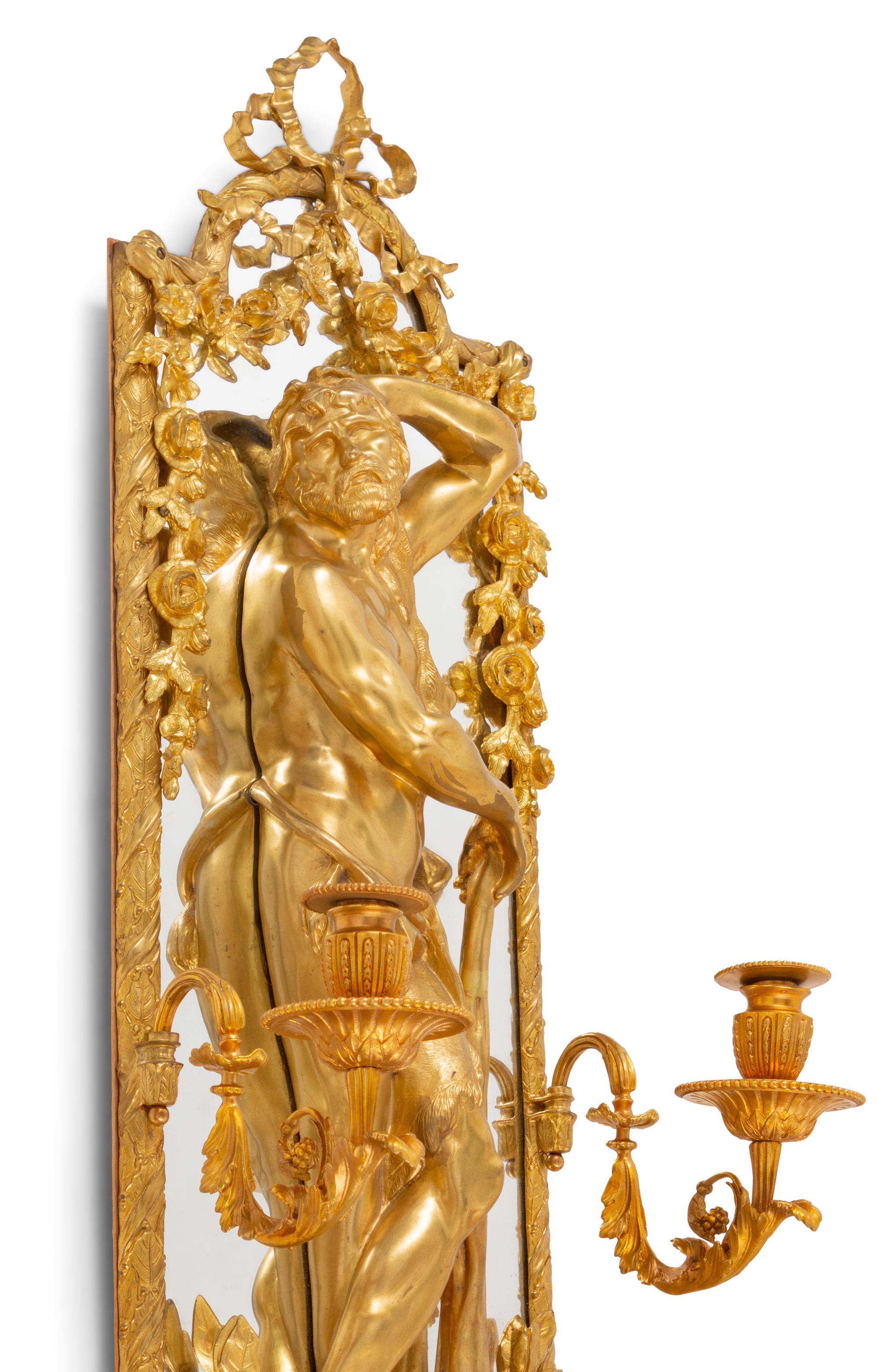 A Pair of Large Louis XVI Style Mirrored Gilt Bronze Figural Sconces