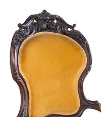 A Victorian Rococo Revival Carved Walnut Armchair