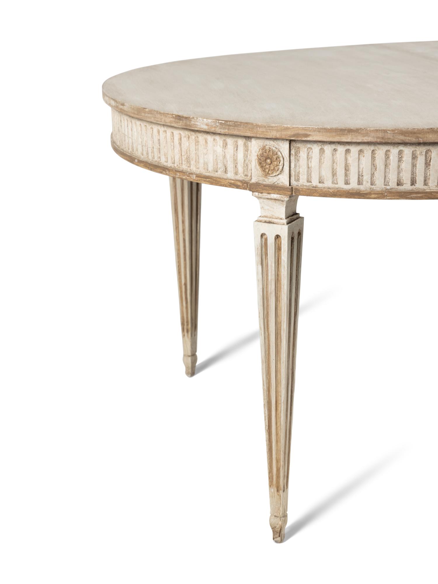 A Dennis and Leen Painted and Parcel-Gilt Dining Suite