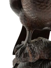 A Japanese Style Carved Rosewood Hawk with Chicks