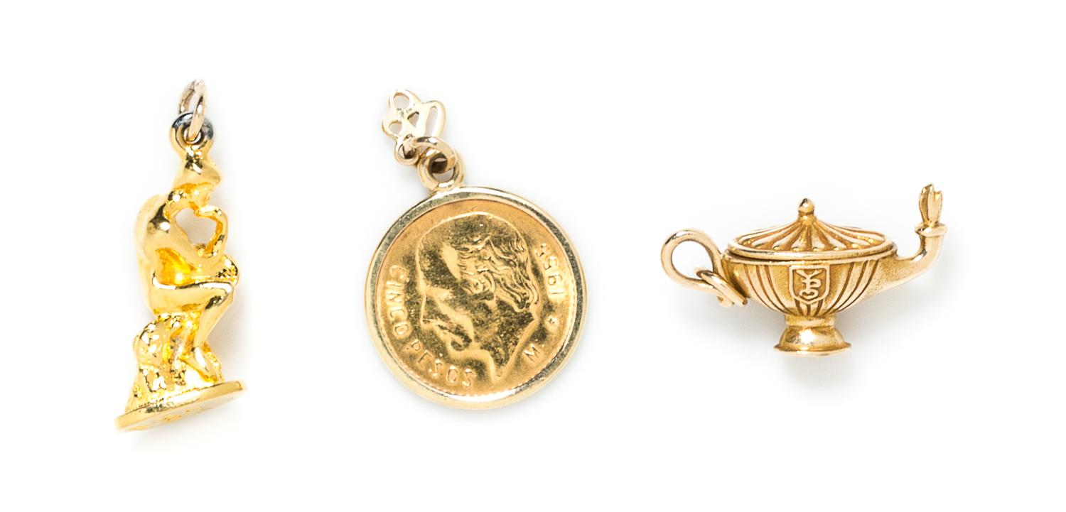 A 14 Karat Yellow Gold Charm Bracelet with 13 Attached and Unattached Gold and Gold Tone Charms, 48.40 dwts.