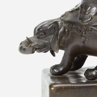 A pair of Japanese "Elephant and Dragon" patinated bronze openwork pricket candlesticks Edo period, 18th/early 19th Century