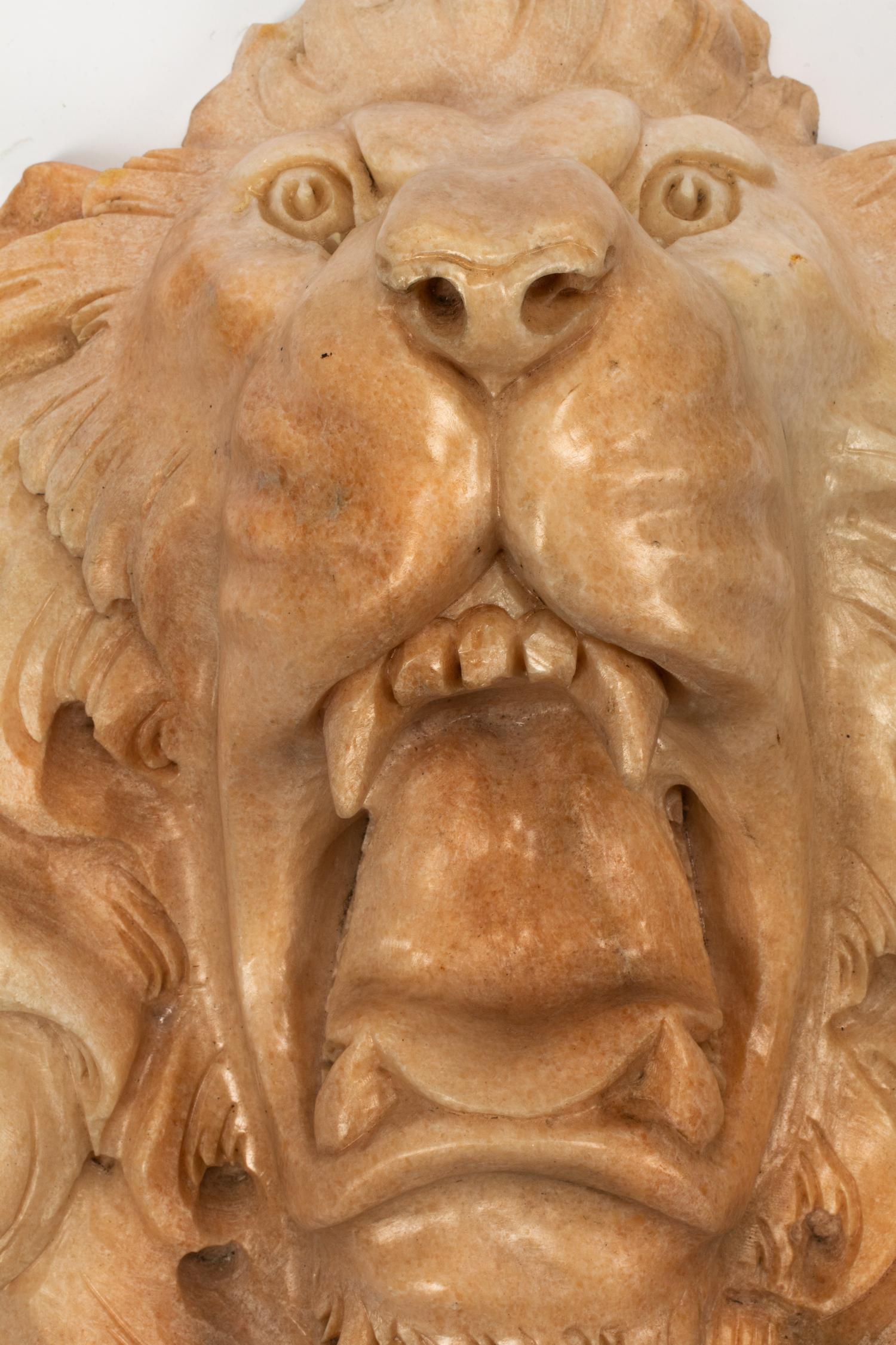 A Continental Carved Marble Lion Mask