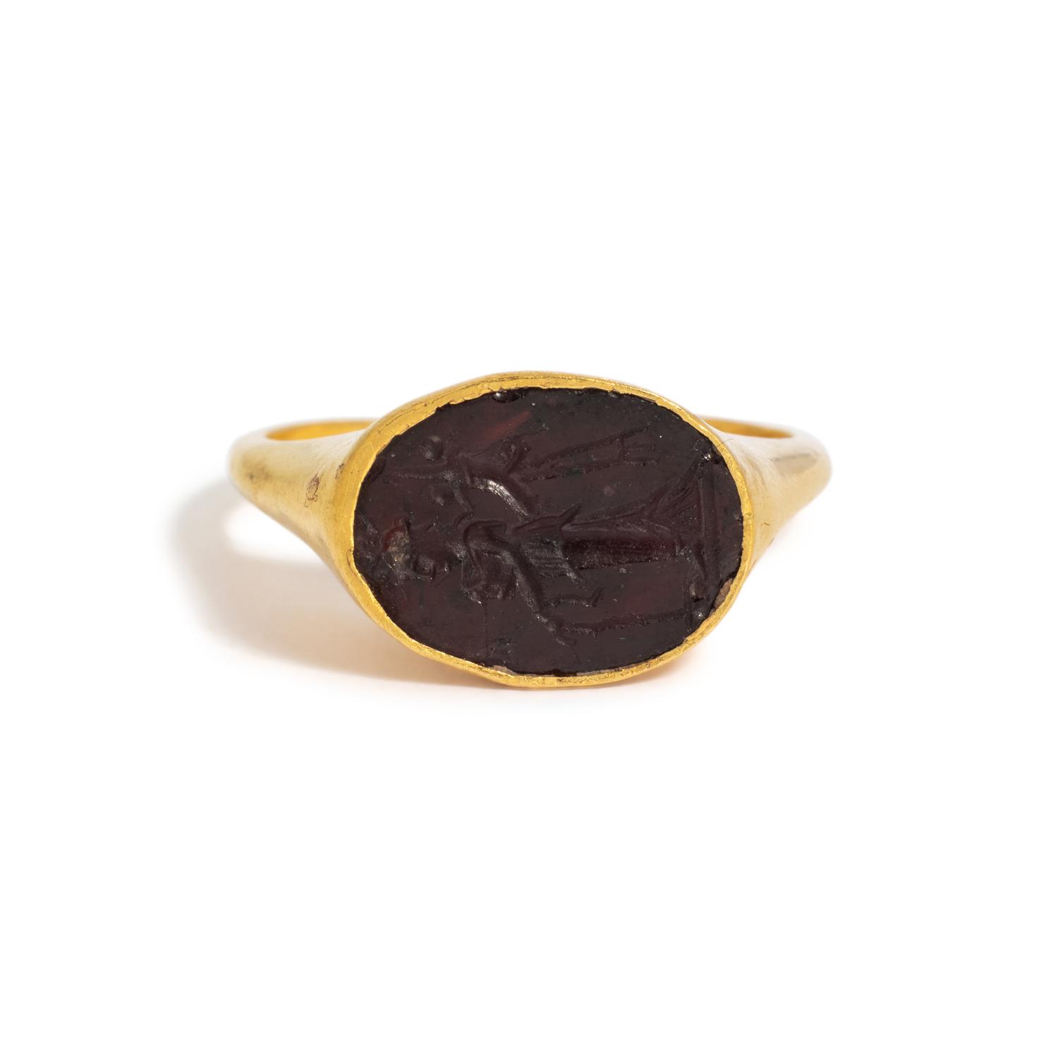 A Roman Gold and Garnet Finger Ring with the Goddess Fortuna Thyche.