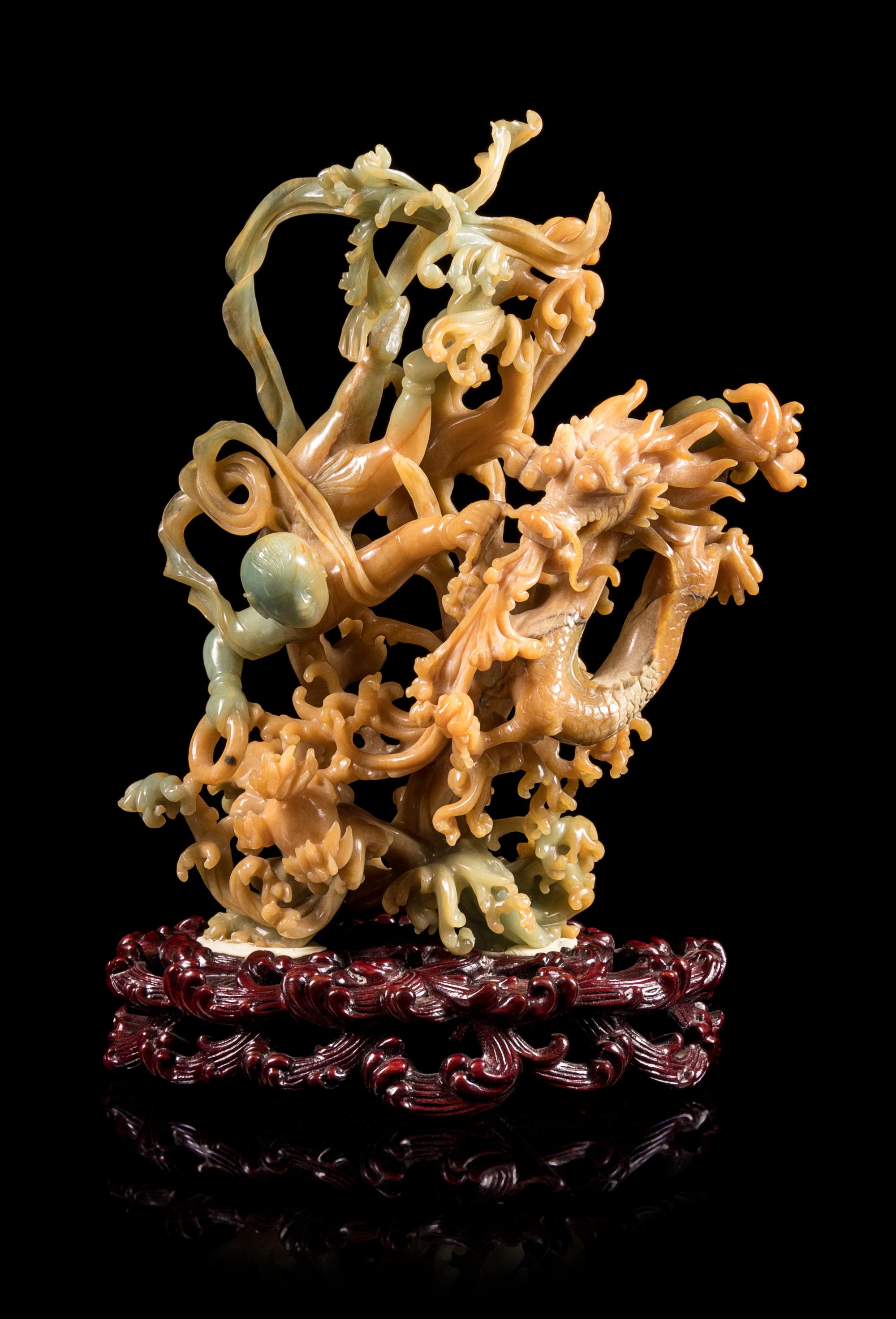 A Russet and Green Jadeite Figural Group of a Boy and Dragon Height 7 inches — 20TH CENTURY