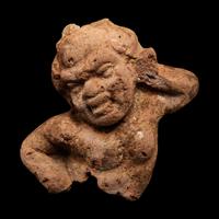 A Nubian Terracotta Head and Reclining Figure