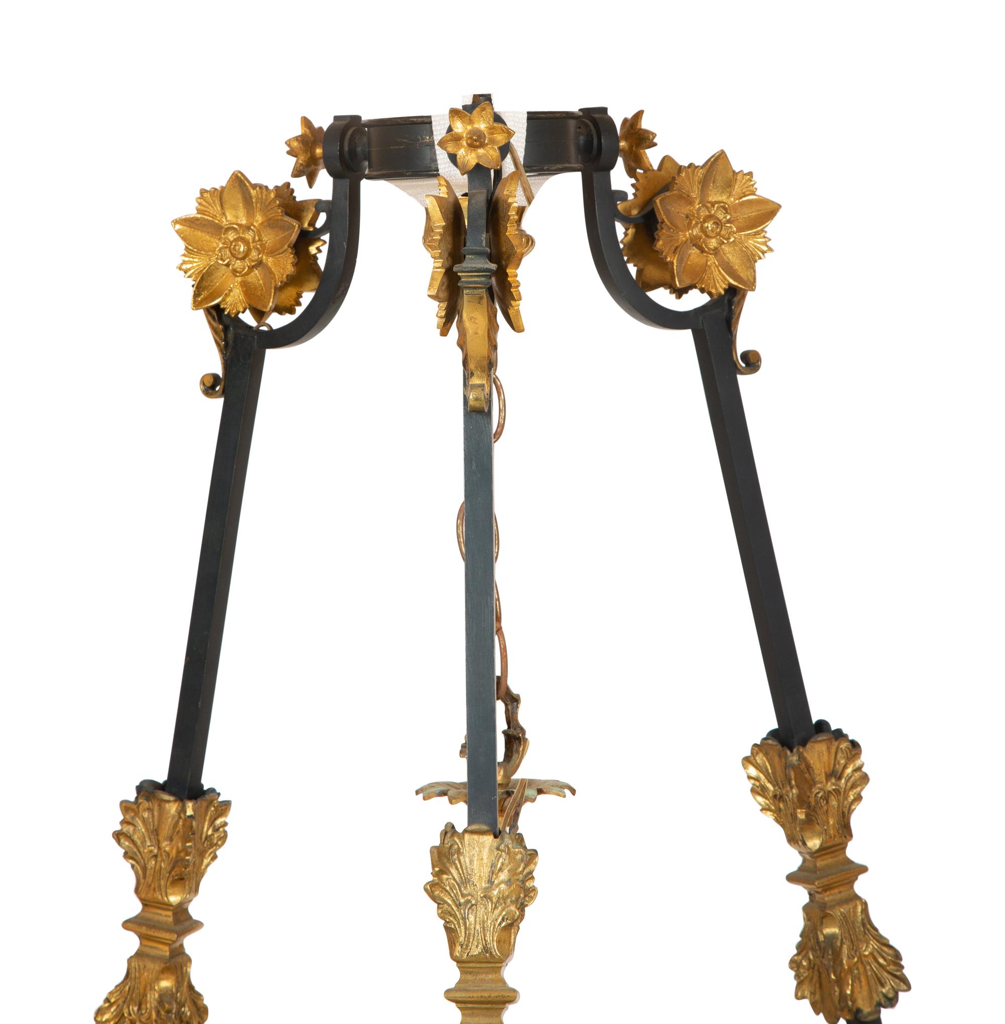 A French Empire Style Ebonized and Gilt Metal Fourteen-Light Chandelier