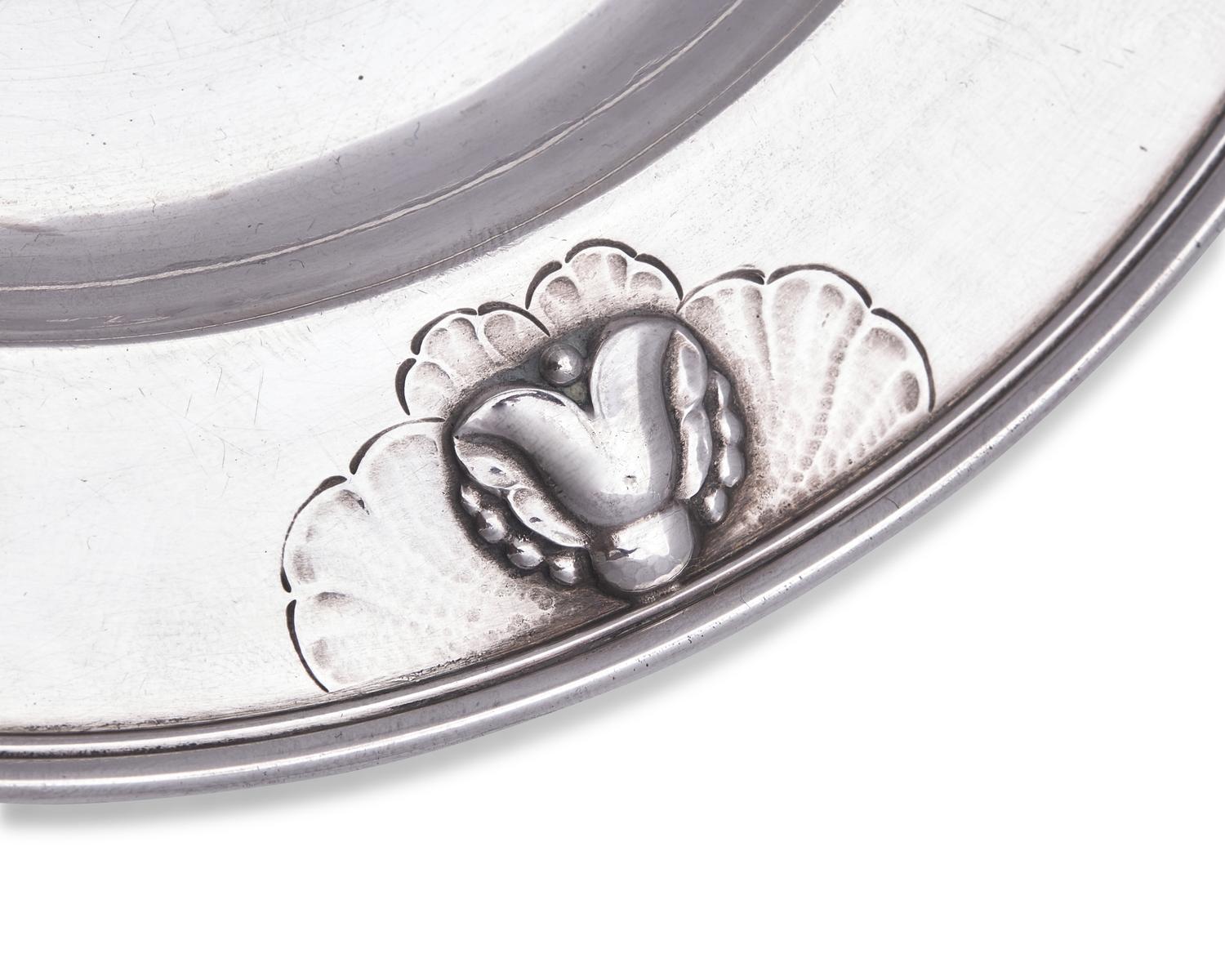 A Set of Twelve Georg Jensen Silver Bread Plates
