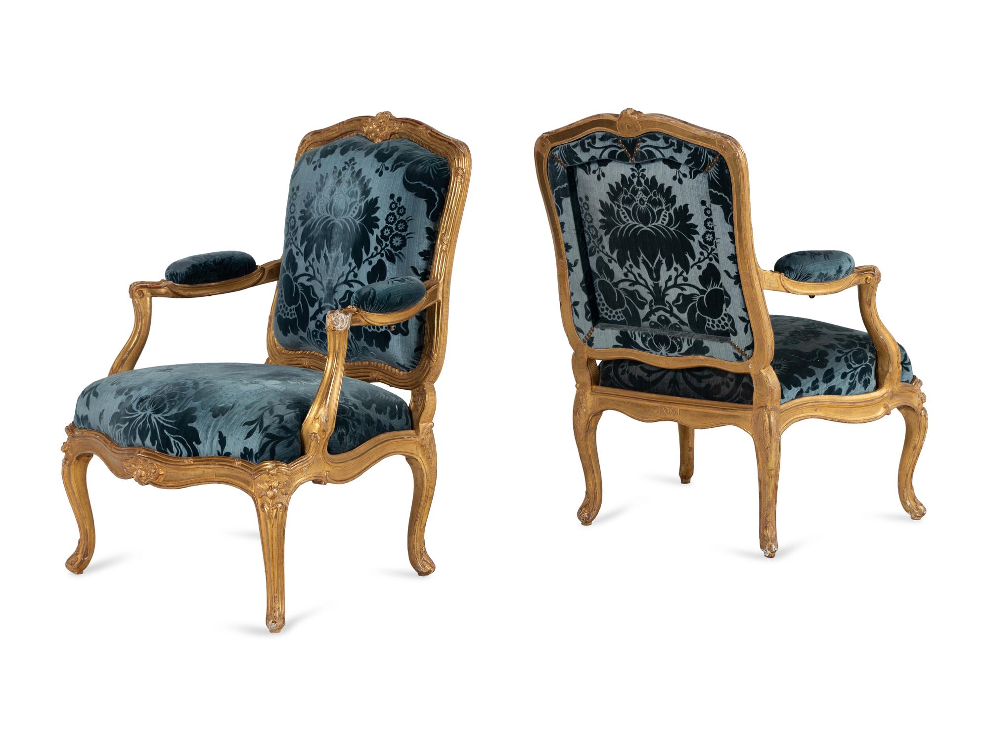 A Pair of Louis XV Carved Giltwood Fauteuils à la Reine