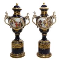 A Pair of Royal Vienna Porcelain Urns, Covers and Stands, Height overall 32 1/4 inches.
