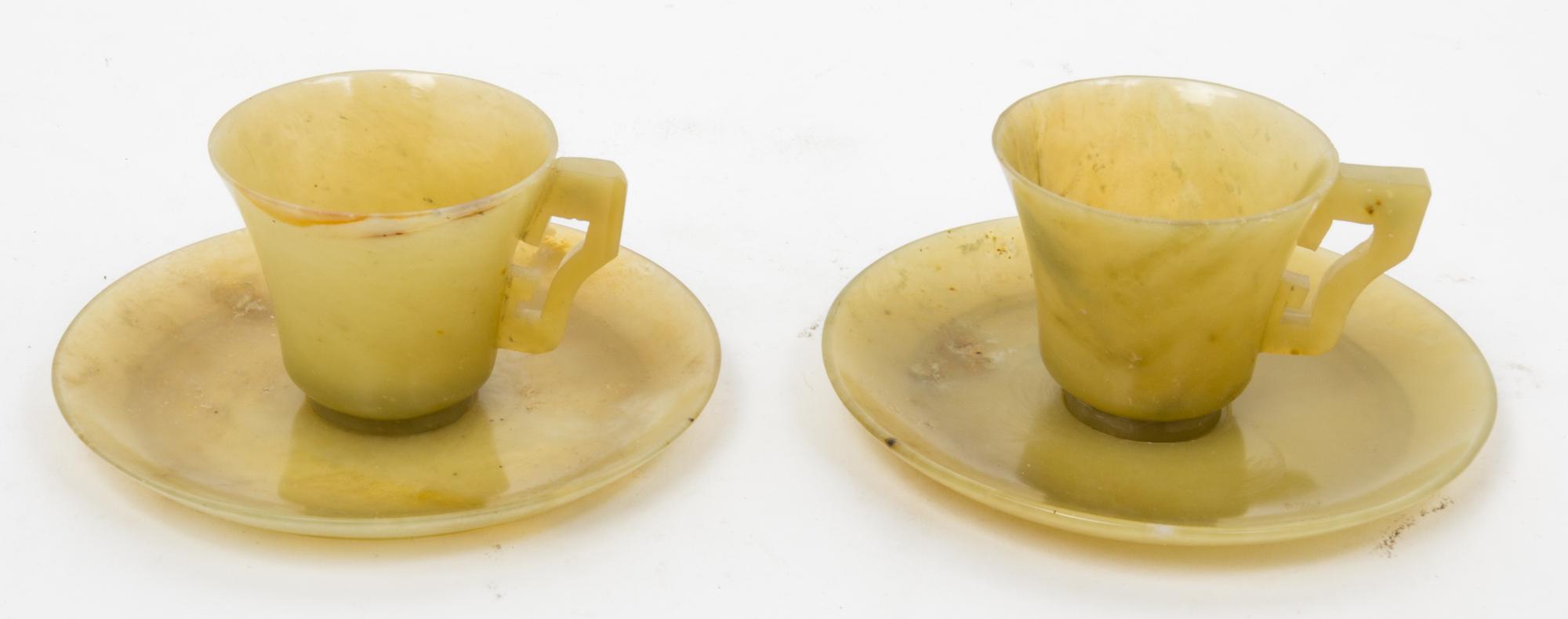 A Pair of Chinese Yellow Jade Cups and Saucers Diameter of saucer 4 3/4 inches.