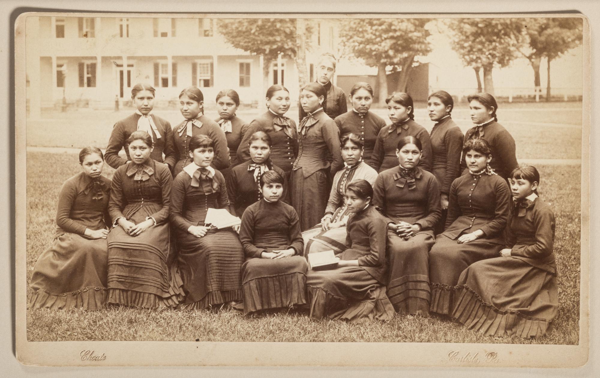 CHOATE, John N. (1848-1902), photographer. Boudoir card of a class of female students with their teacher at Carlisle Indian School. Carlisle, PA, n.d.