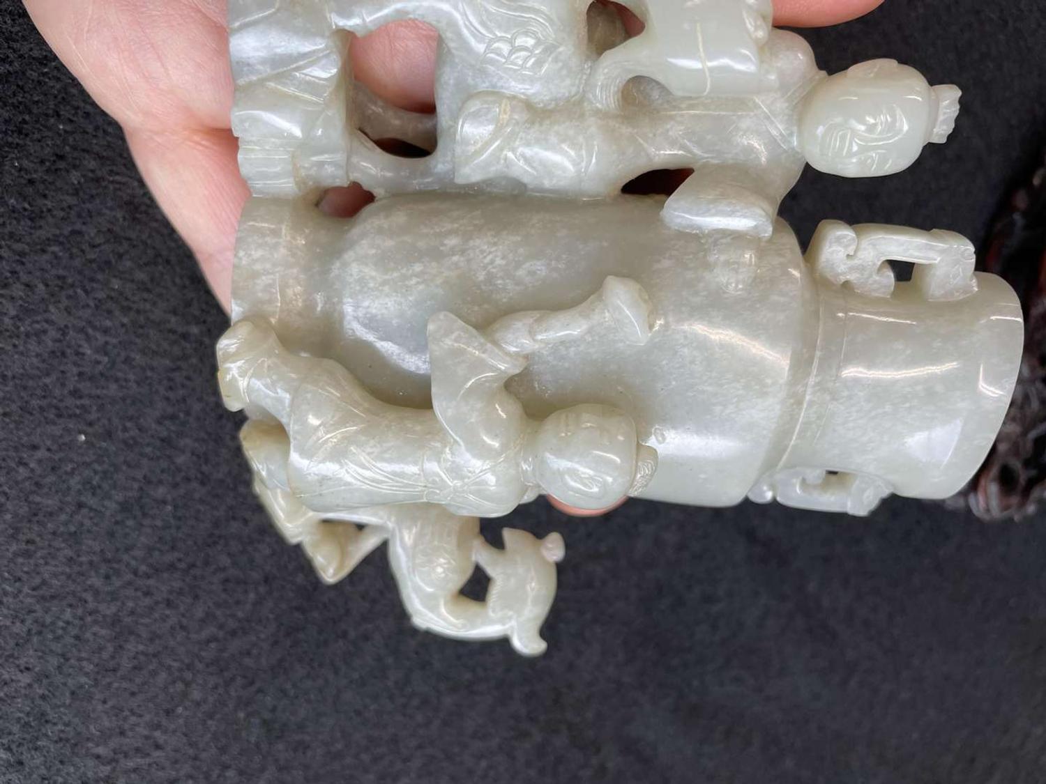 A Chinese jade "Boys, Kylin and Phoenix" vase on carved wood stand 玉雕童子凤鸟花樽及底座