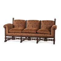 A Jacobean Style Carved Oak Sofa and Armchair