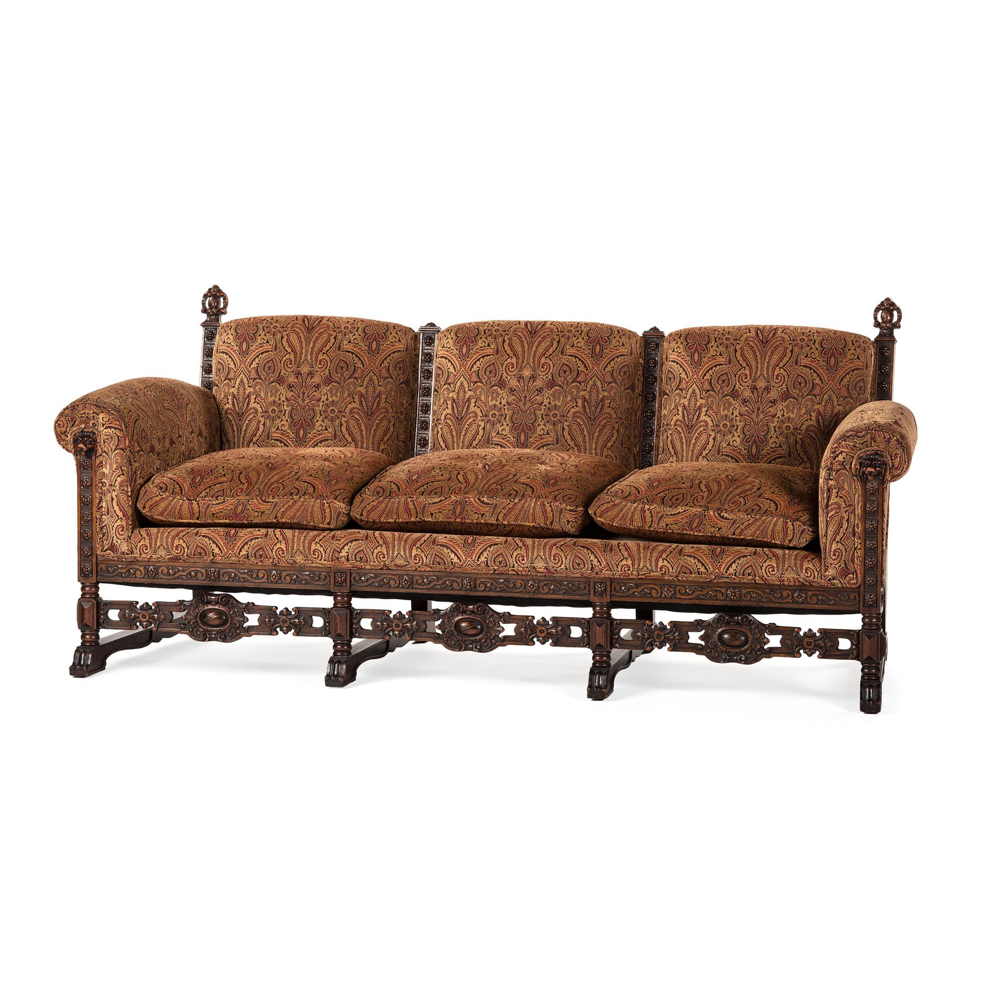 A Jacobean Style Carved Oak Sofa and Armchair
