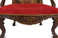 A Régence Style Carved Walnut Bergère à Oreilles with Petit Point Upholstery