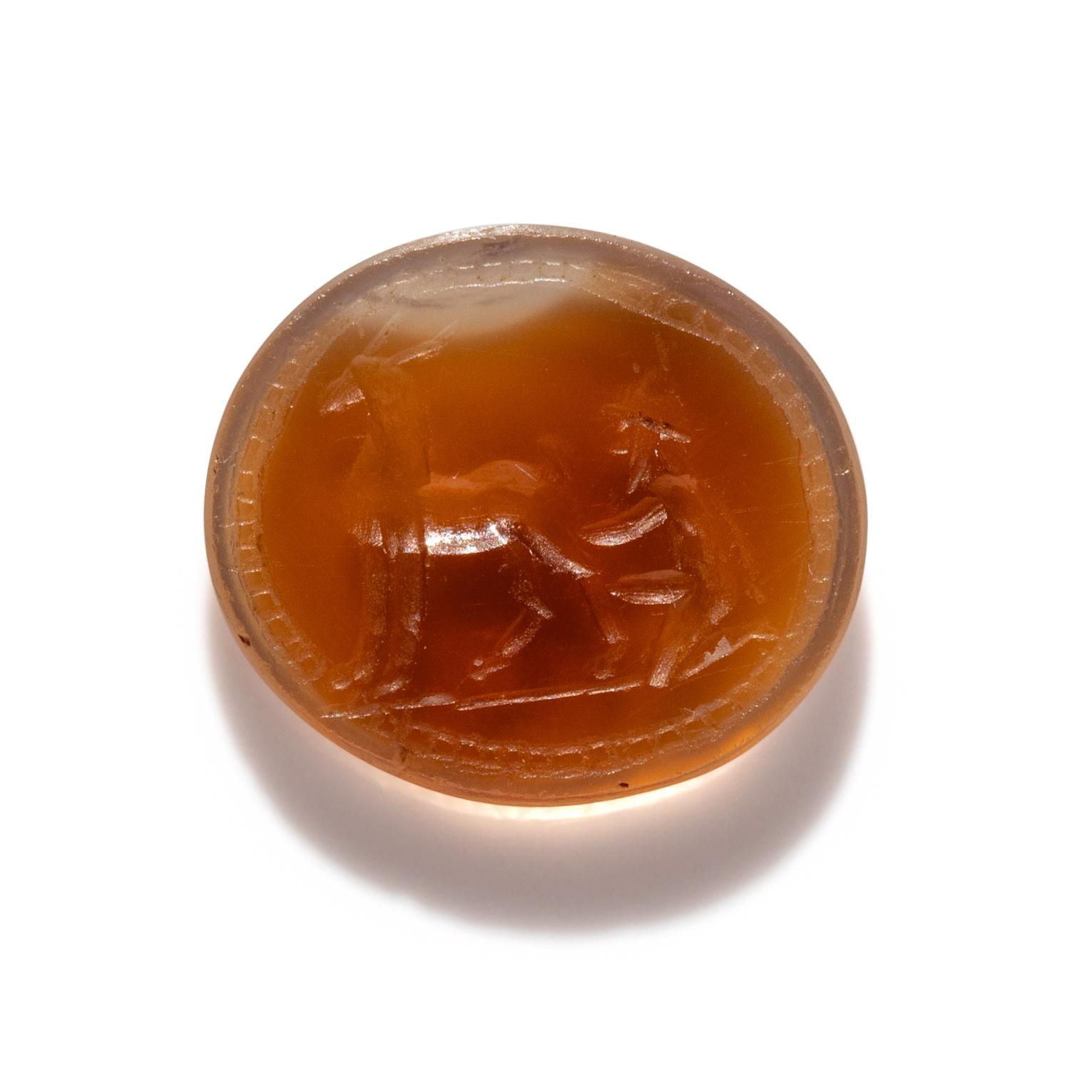 A Roman Carnelian Ring Stone with a Goatherder Milking a Goat
