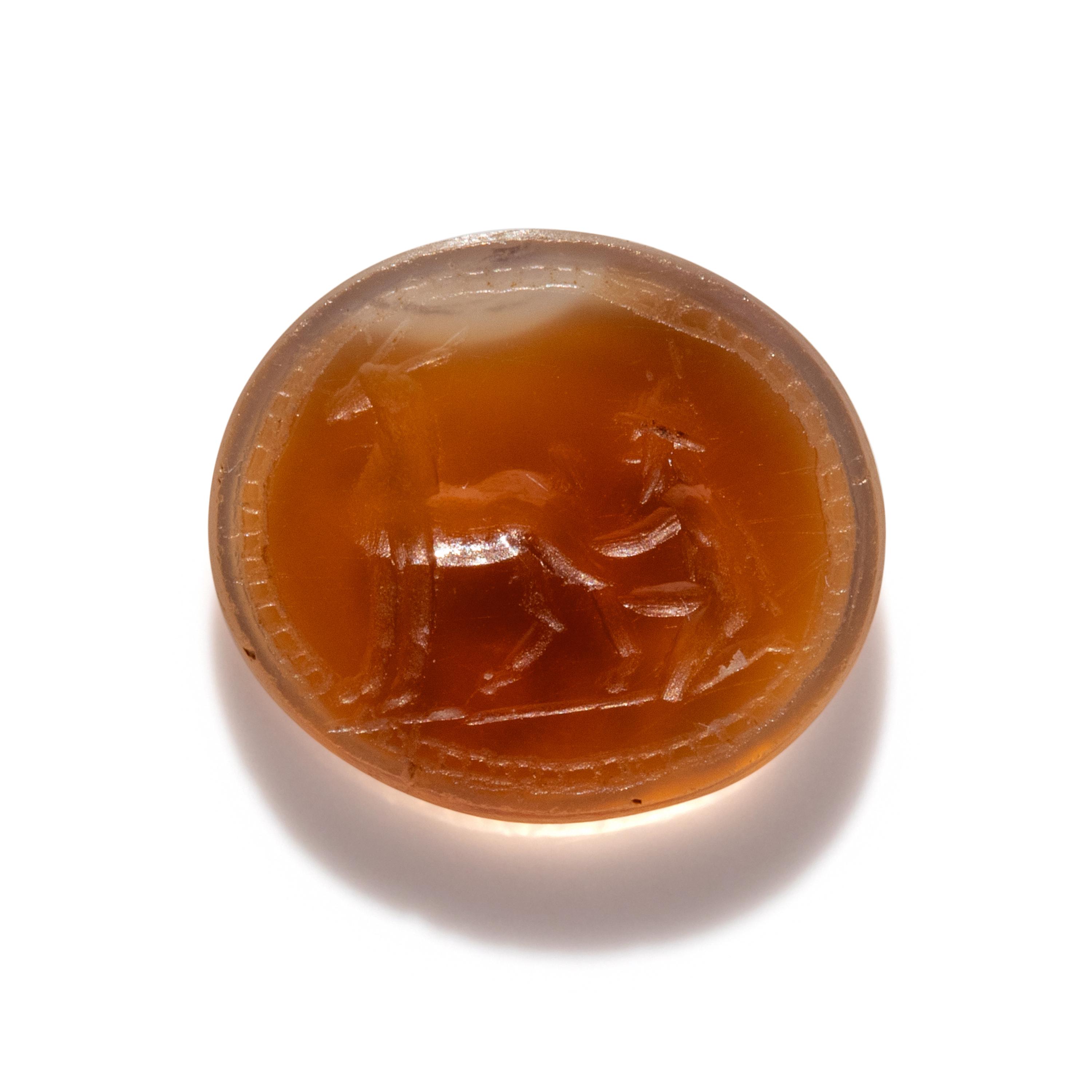 A Roman Carnelian Ring Stone with a Goatherder Milking a Goat