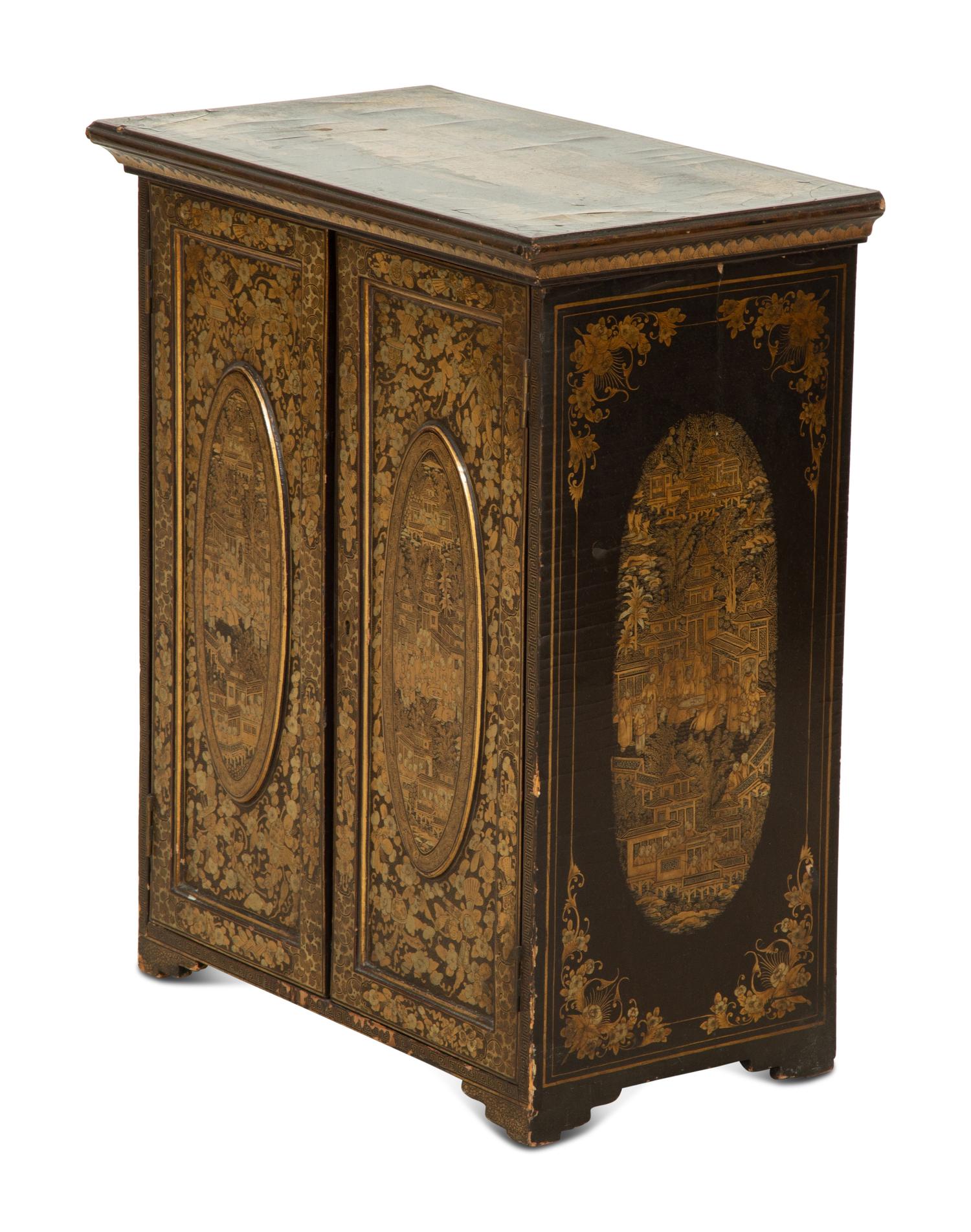 An English Black and Gilt Chinoiserie Decorated Cabinet with Interior Drawers