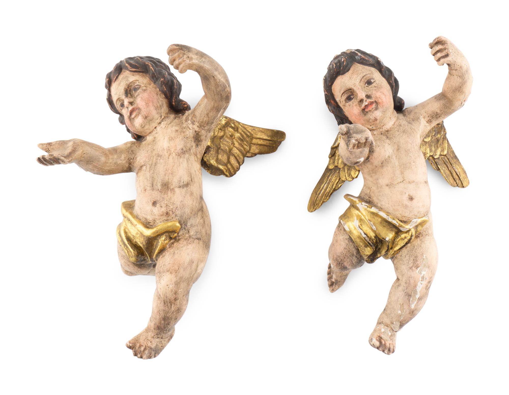 A Pair of Continental Painted and Parcel Gilt Putto Ornaments