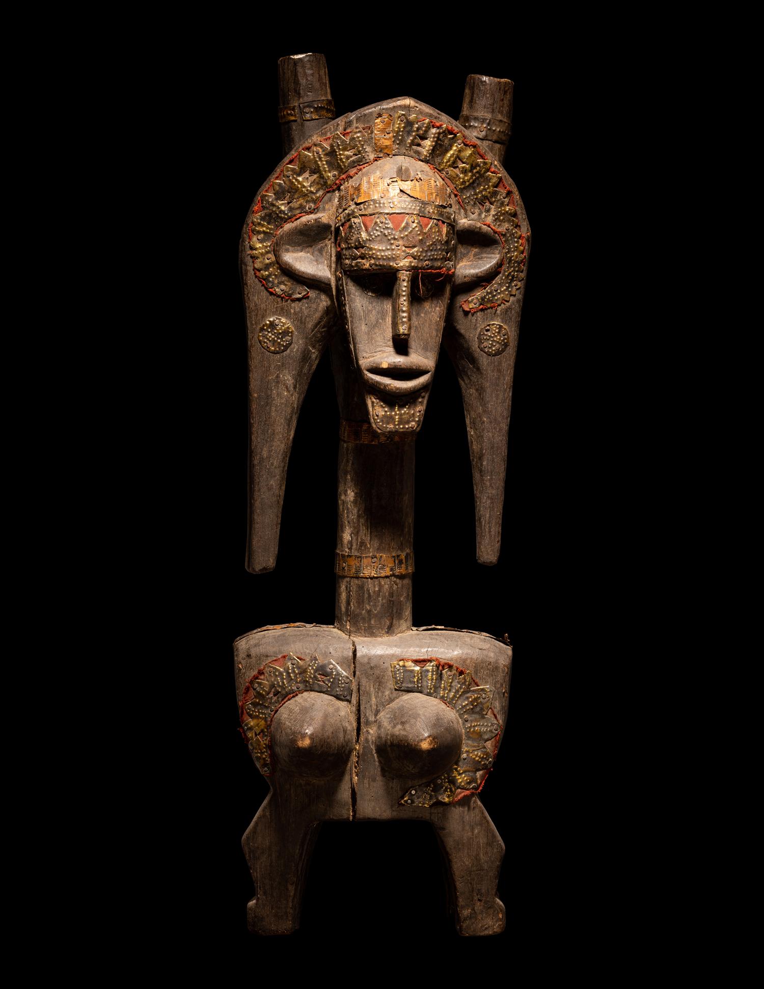A Bamana Wood Marionette Figure with Eight Wood Puppet Heads