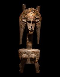 A Bamana Wood Marionette Figure with Eight Wood Puppet Heads
