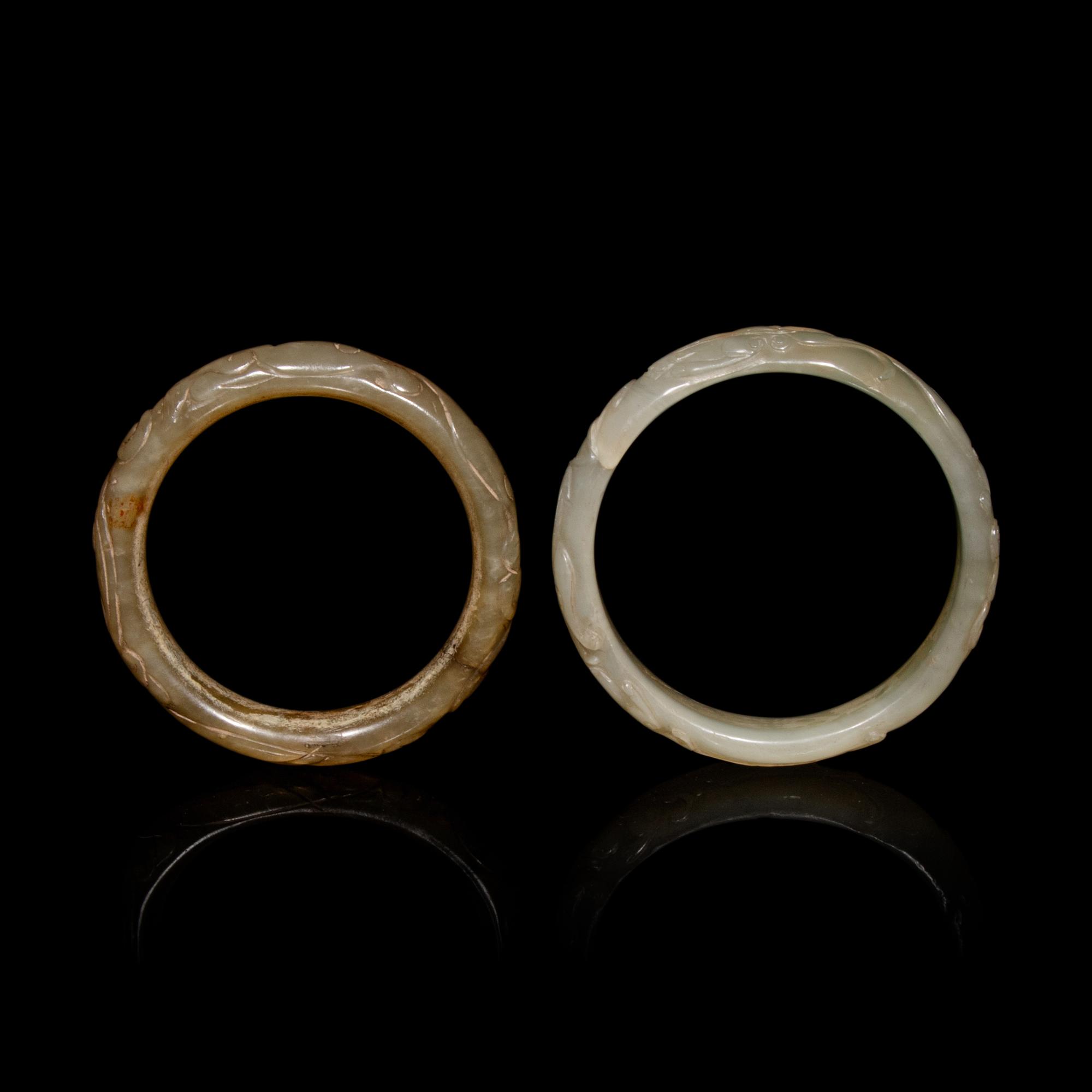 Two Chinese Carved Precious Stone Bangles, Qing Dynasty or Earlier 清或以前 青玉、瑪瑙雕螭龍紋鐲各一